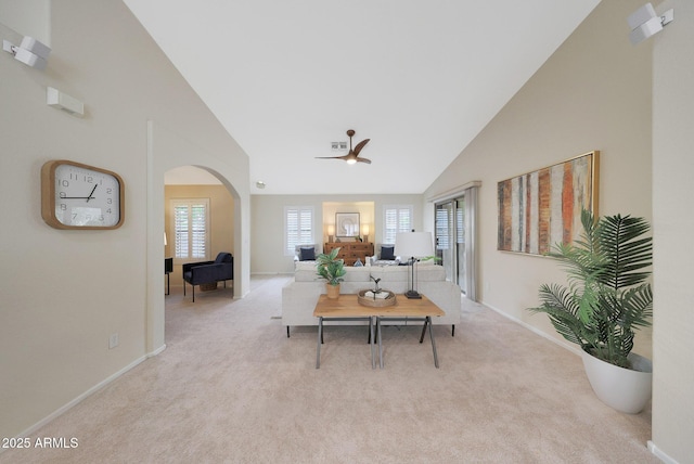 2627 E Gary Way, Phoenix, AZ 85042 - living room with arched walkways, ceiling fan, baseboards, carpet, and high vaulted ceiling