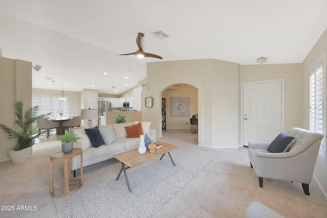 2627 E Gary Way, Phoenix, AZ 85042 - living room featuring arched walkways, light colored carpet, plenty of natural light, baseboards, and lofted ceiling