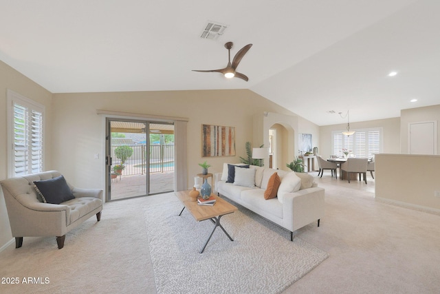 2627 E Gary Way, Phoenix, AZ 85042 - living room featuring light carpet, lofted ceiling, arched walkways, baseboards, and a ceiling fan