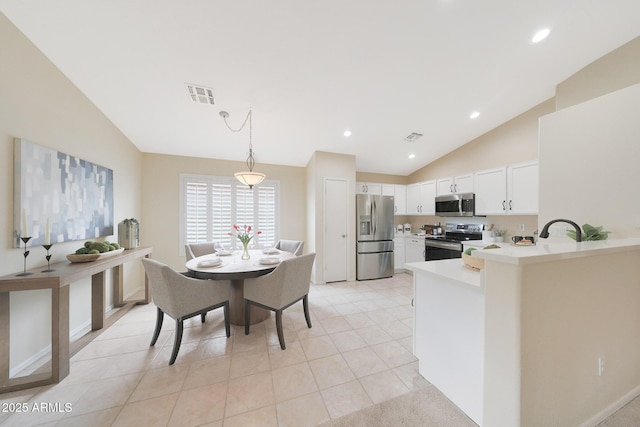 2627 E Gary Way, Phoenix, AZ 85042 - kitchen featuring stainless steel appliances, vaulted ceiling, light countertops, a peninsula, and white cabinets