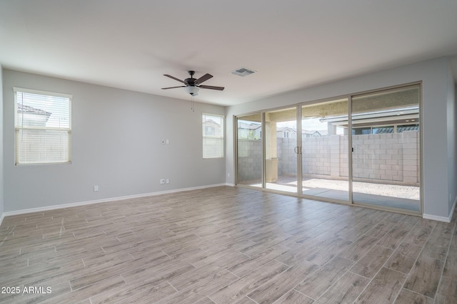 unfurnished bedroom featuring multiple windows, light wood-type flooring, and access to exterior