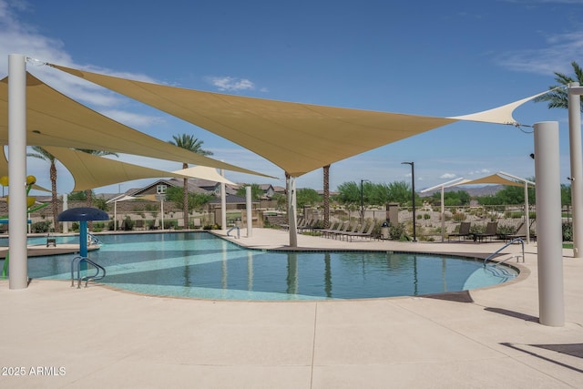 pool featuring a patio area and fence
