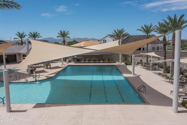 pool featuring a patio area and a mountain view