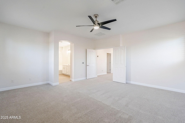 4389 E Muirfield St, Gilbert, AZ 85298 - unfurnished bedroom with baseboards, light carpet, ensuite bath, visible vents, and arched walkways