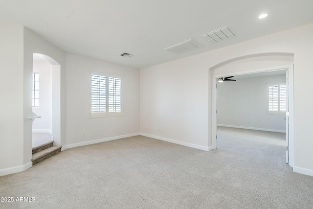 4389 E Muirfield St, Gilbert, AZ 85298 - unfurnished room featuring visible vents, baseboards, arched walkways, and light carpet