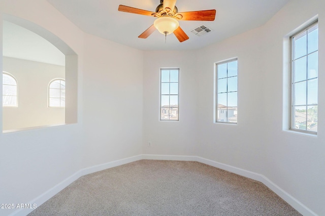4389 E Muirfield St, Gilbert, AZ 85298 - empty room with visible vents, arched walkways, and a healthy amount of sunlight