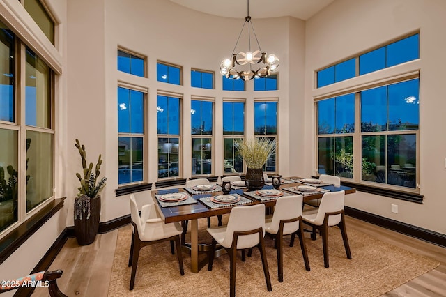 28609 N Cottonwood Basin Dr, Rio Verde, AZ 85263 - dining area featuring wood finished floors, a chandelier, baseboards, and a towering ceiling