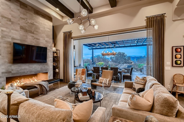 28609 N Cottonwood Basin Dr, Rio Verde, AZ 85263 - living room with beamed ceiling, a tiled fireplace, and wood finished floors
