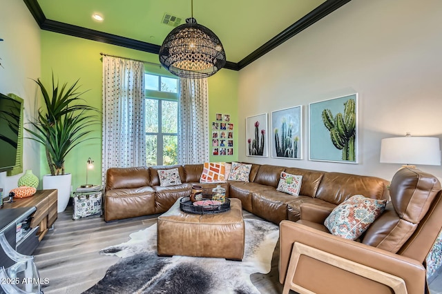 28609 N Cottonwood Basin Dr, Rio Verde, AZ 85263 - living room featuring ornamental molding, a chandelier, and wood finished floors
