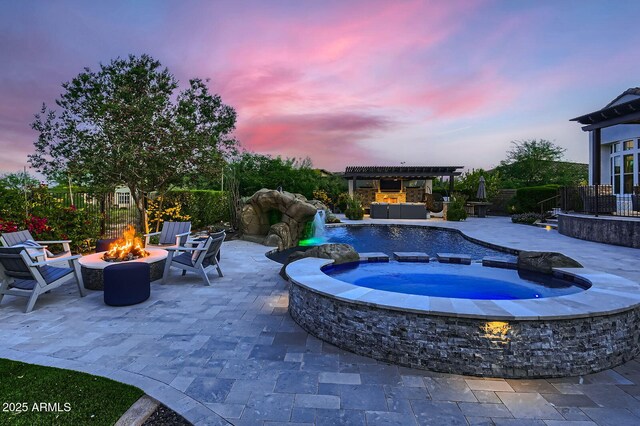 28609 N Cottonwood Basin Dr, Rio Verde, AZ 85263 - pool at dusk featuring an outdoor fire pit, an in-ground hot tub, a pergola, and a patio