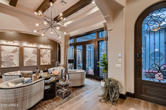 28609 N Cottonwood Basin Dr, Rio Verde, AZ 85263 - foyer entrance featuring arched walkways, french doors, wood finished floors, a chandelier, and beam ceiling