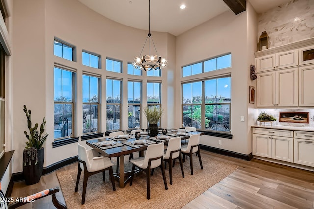 28609 N Cottonwood Basin Dr, Rio Verde, AZ 85263 - dining space with a chandelier, a high ceiling, light wood-style flooring, baseboards, and recessed lighting