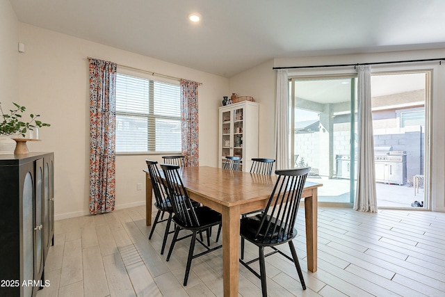 dining area with light wood finished floors and baseboards