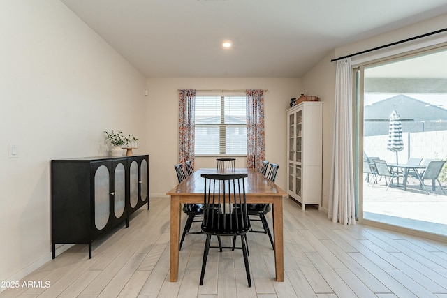 dining space with recessed lighting, baseboards, and light wood-type flooring