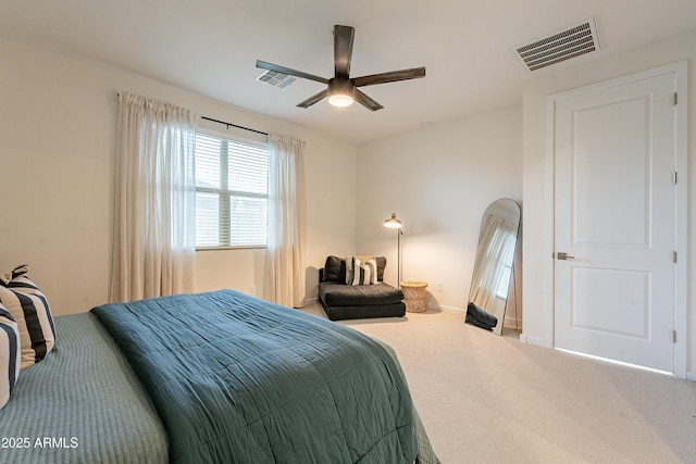 carpeted bedroom with visible vents, ceiling fan, and baseboards