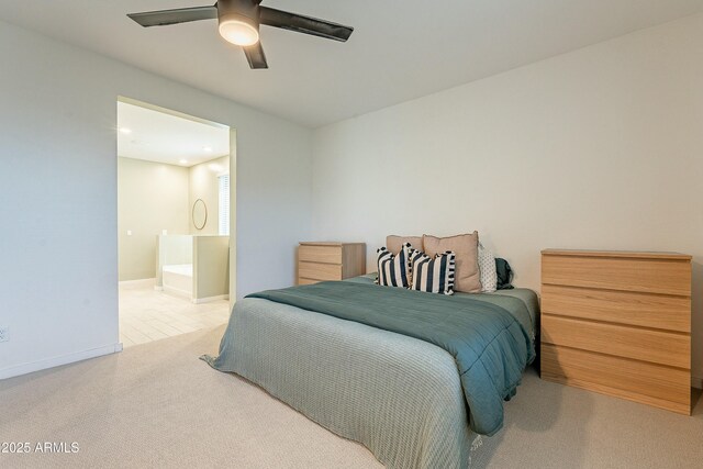 carpeted bedroom with baseboards, ensuite bathroom, and ceiling fan