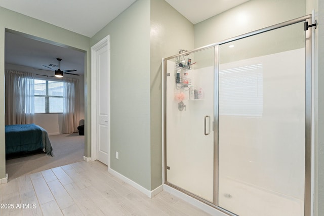 ensuite bathroom with ensuite bath, wood finished floors, a shower stall, and ceiling fan