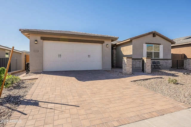 view of front of property with stucco siding, an attached garage, decorative driveway, and fence