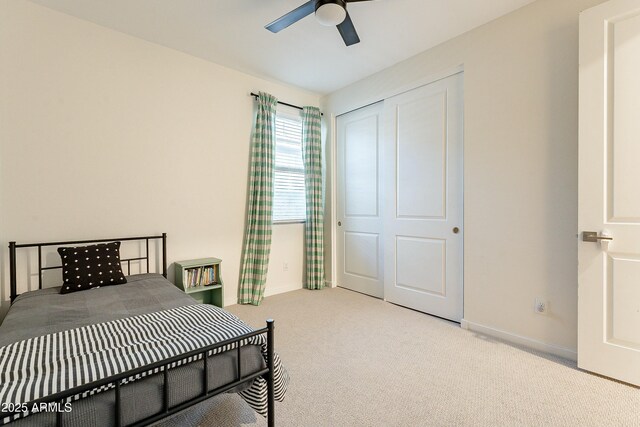 bedroom featuring a closet, baseboards, carpet, and a ceiling fan