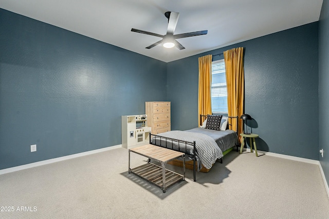 carpeted bedroom with a ceiling fan and baseboards