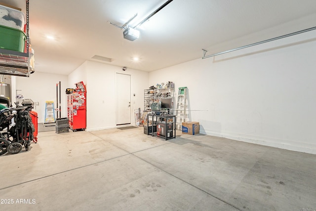 garage featuring a garage door opener and baseboards