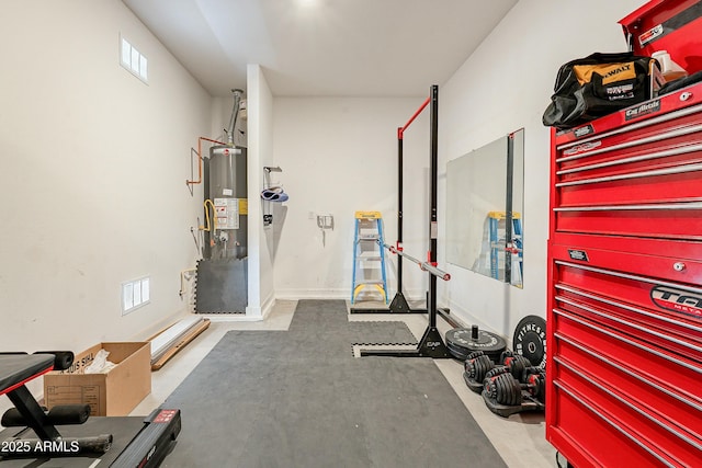 workout room with visible vents and water heater