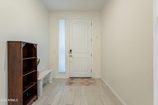 entrance foyer with light wood finished floors and baseboards