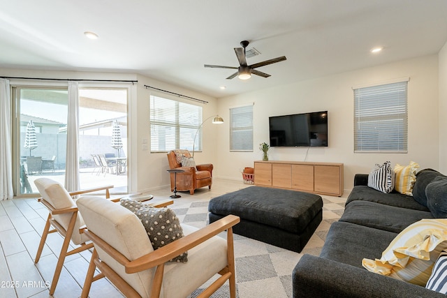 living area with a ceiling fan, recessed lighting, visible vents, and baseboards