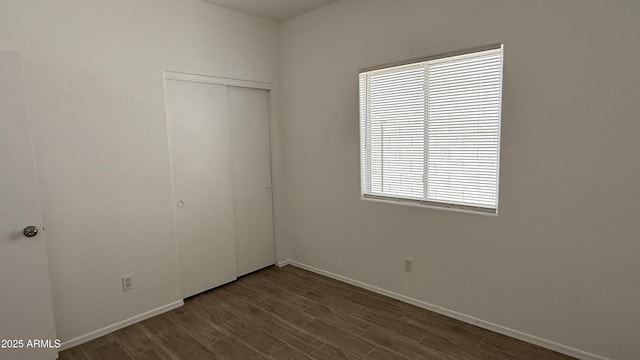 12505 W Adams St, Avondale, AZ 85323 - unfurnished bedroom with a closet and dark wood-type flooring