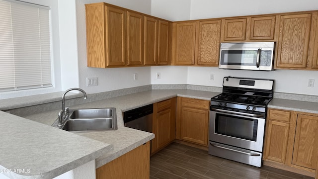 12505 W Adams St, Avondale, AZ 85323 - kitchen featuring appliances with stainless steel finishes, dark wood-style floors, light countertops, and a peninsula
