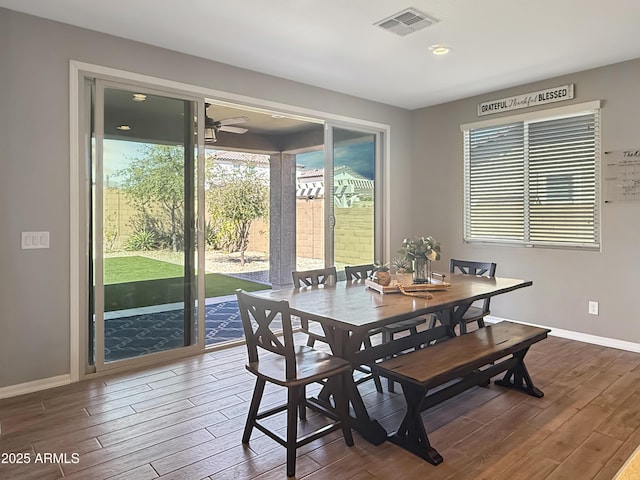 dining room featuring ceiling fan, dark wood-style floors, visible vents, and baseboards