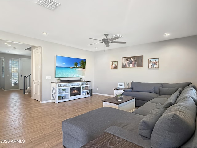 living room featuring visible vents, baseboards, ceiling fan, recessed lighting, and wood finished floors