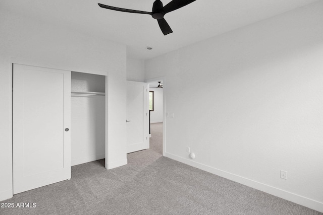 unfurnished bedroom featuring ceiling fan, a closet, and light carpet