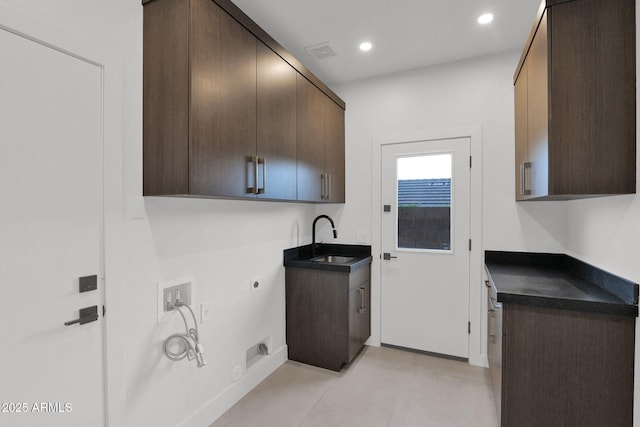 washroom with sink, cabinets, washer hookup, hookup for an electric dryer, and hookup for a gas dryer