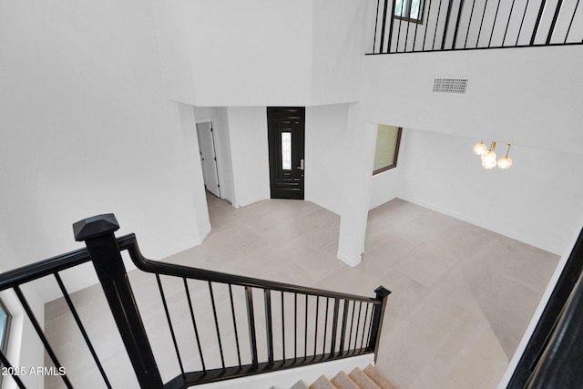 staircase with a high ceiling