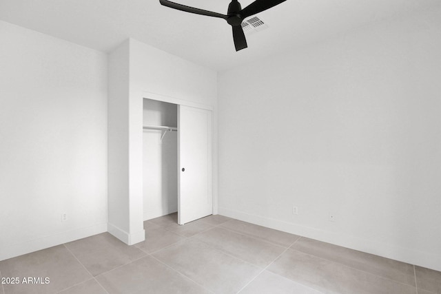 unfurnished bedroom featuring a closet, ceiling fan, and light tile patterned flooring