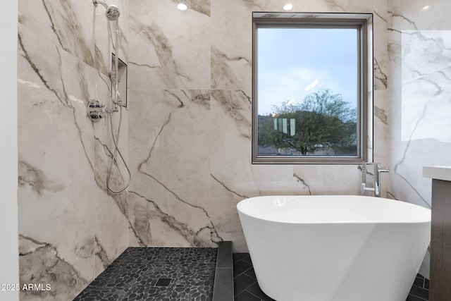 bathroom featuring plus walk in shower and tile walls