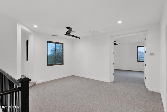 carpeted empty room featuring ceiling fan