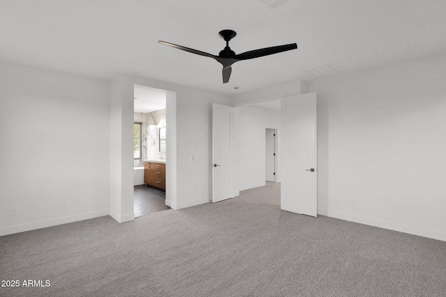 unfurnished room with ceiling fan and light carpet