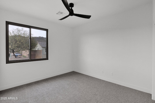 empty room with ceiling fan and carpet flooring