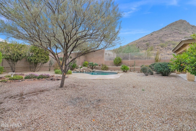 view of yard with a fenced in pool and a mountain view