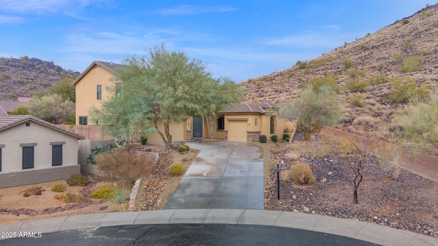 view of front of home featuring a mountain view and a garage