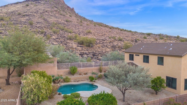 view of swimming pool with a mountain view