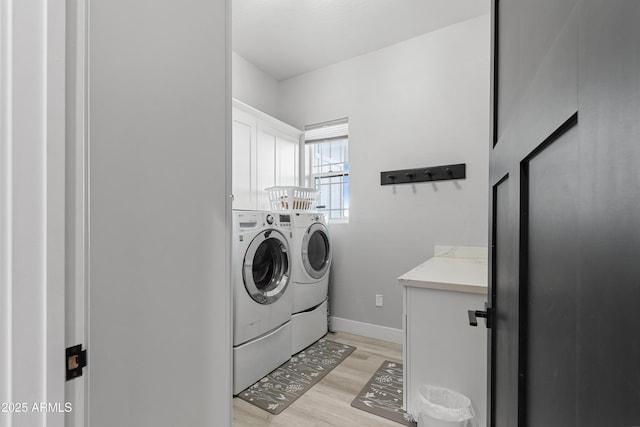 1305 N 22nd Ave, Show Low, AZ 85901 - laundry area featuring independent washer and dryer, cabinet space, light wood-style floors, and baseboards