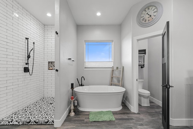 1305 N 22nd Ave, Show Low, AZ 85901 - bathroom with tiled shower, a soaking tub, toilet, wood finished floors, and baseboards