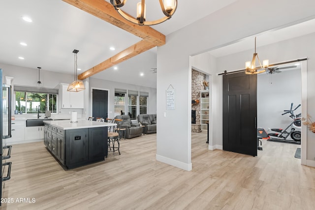1305 N 22nd Ave, Show Low, AZ 85901 - kitchen featuring a barn door, a sink, recessed lighting, light countertops, and white cabinets