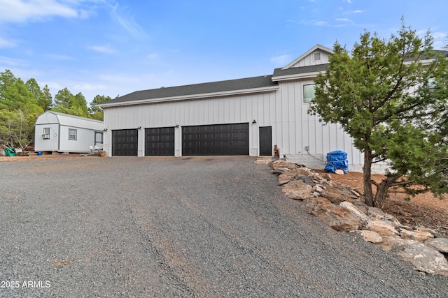 1305 N 22nd Ave, Show Low, AZ 85901 - view of side of home with roof with shingles, a garage, gravel driveway, and board and batten siding