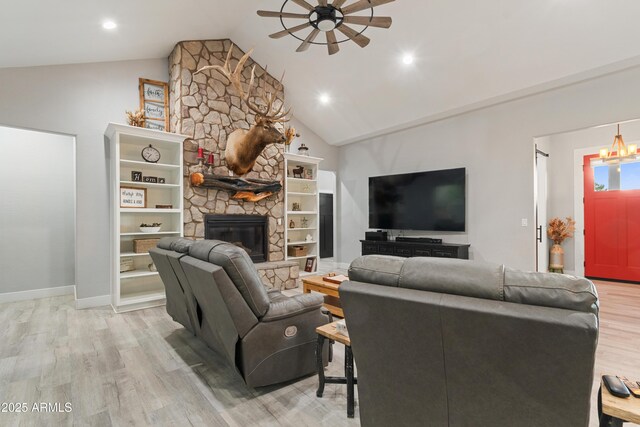 1305 N 22nd Ave, Show Low, AZ 85901 - living room with a ceiling fan, light wood-style flooring, vaulted ceiling, a stone fireplace, and recessed lighting