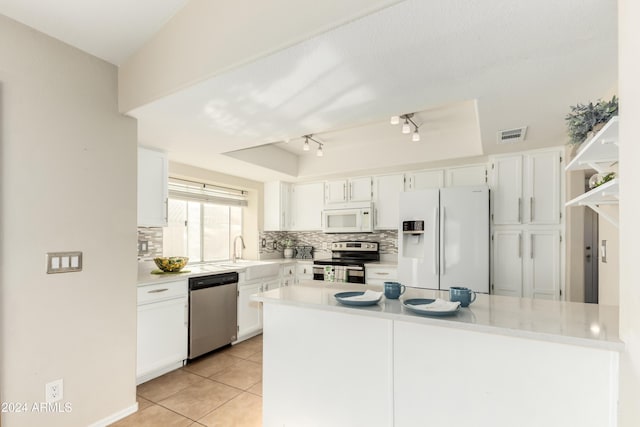 kitchen with sink, white cabinetry, stainless steel appliances, and track lighting