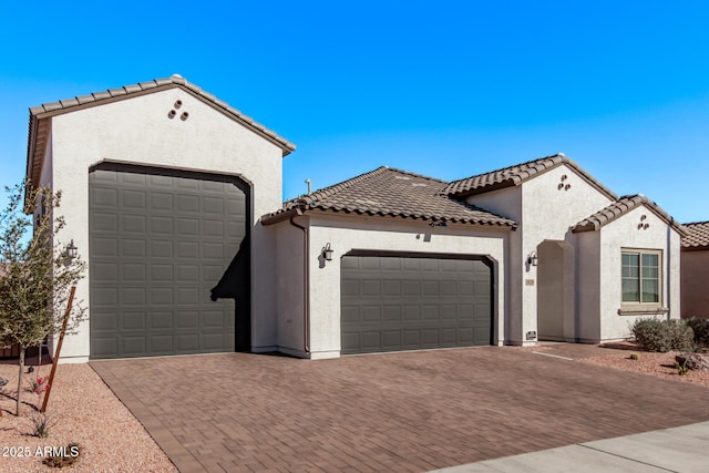 mediterranean / spanish-style house with a garage